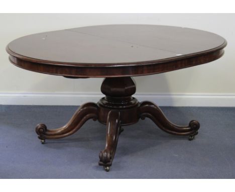 A mid-Victorian mahogany 'D' end extending dining table, the moulded top raised on a single octagonal baluster column and fou