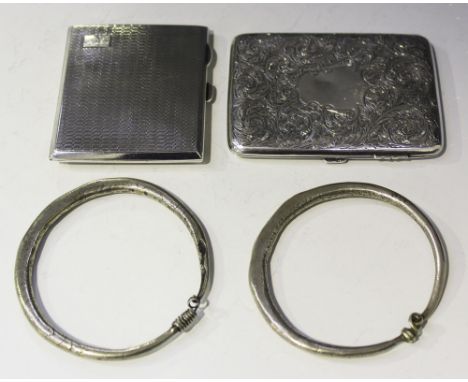 A late Victorian silver cigarette case with engine turned foliate scroll decoration, Birmingham 1898, a later silver cigarett