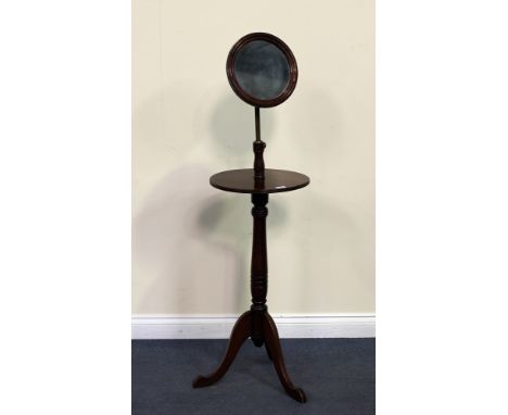 A Victorian mahogany dressing stand, fitted with a circular mirror above a single tier, raised on a turned stem and tripod le