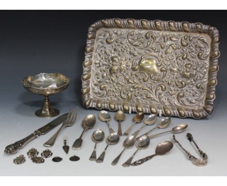 An Edwardian silver rectangular dressing table tray, embossed with scroll and foliate decoration with a raised gadrooned rim,