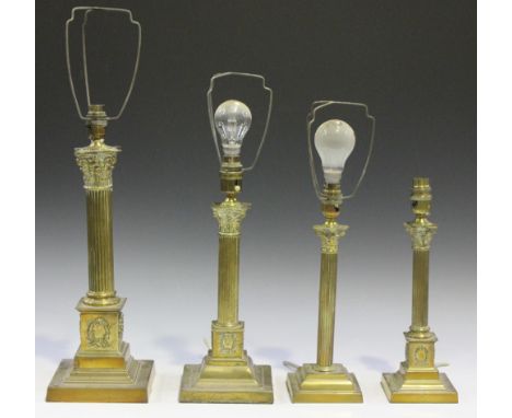 A 20th Century brass Corinthian column table lamp, height approx 42cm, together with three other brass table lamps.