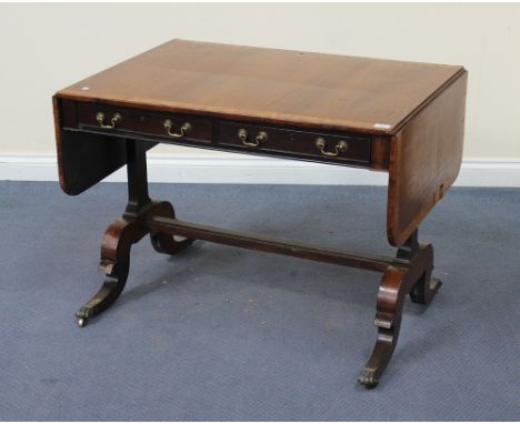 A Regency rosewood and satinwood crossbanded sofa table, fitted with two frieze drawers, raised on shaped sabre legs with bra