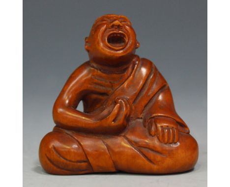 A Japanese carved boxwood netsuke, Meiji period, modelled as a blind beggar, seated wearing a robe, incised signature to base