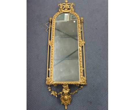 A 19th Century gilt painted pier mirror, the arched frame with a foliate scrolling surmount above a shelf apron with cartouch