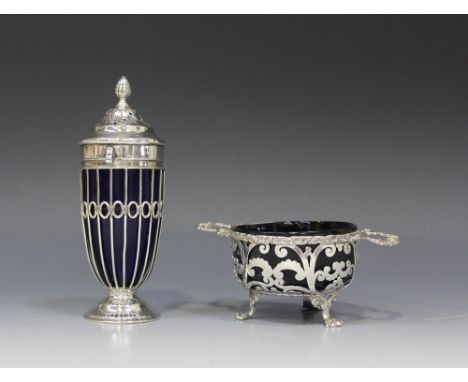 An Edwardian silver wirework sugar caster with blue glass liner, the pierced domed cover with reeded finial, on a circular fo