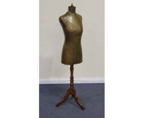 A late 19th Century dressmaker's dummy with a turned walnut stem and tripod base, height approx 154cm.