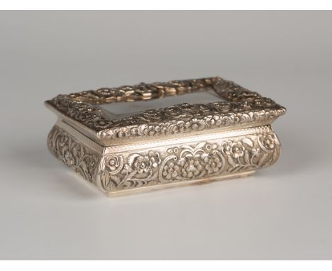 A William IV silver rectangular table snuffbox, the hinged lid finely cast with a floral and foliate scroll border, repeated 
