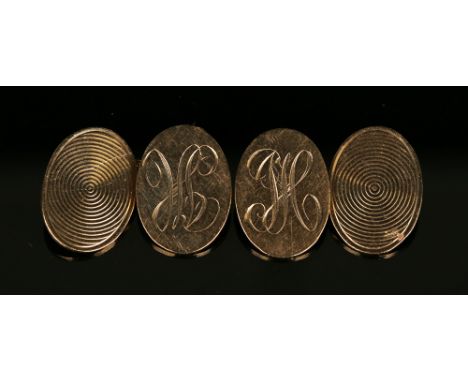 A pair of 9ct gold oval cufflinks, engine turned to one side and monogram engraved to the other side, Birmingham 1955.