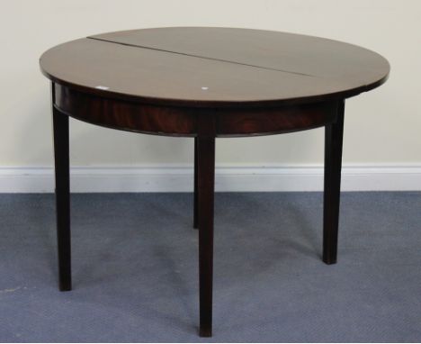 A George III mahogany circular drop-flap supper table, raised on block legs, height approx 73cm, width approx 110cm.