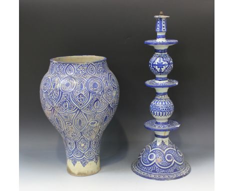A Moroccan blue and white tin glazed earthenware vase, late 19th Century, the baluster body painted with an all-over foliate 