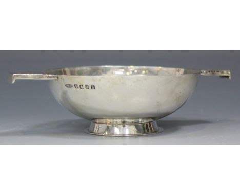 A Scottish silver quaich, the shallow circular bowl engraved with a Celtic cross and applied with a pair of flat tab handles 