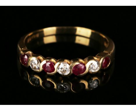 An 18ct gold, ruby and diamond half-hoop ring, mounted with four circular cut rubies alternating with three circular cut diam