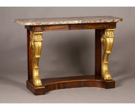 A Regency rosewood and giltwood console table with an associated rouge marble top, the plain frieze above a pair of heavy car