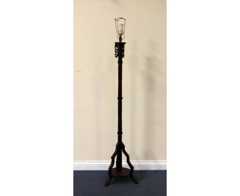 A Chinese hardwood lamp standard, early 20th Century, carved in the form of simulated bamboo, height approx 154cm.