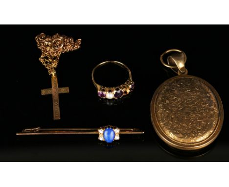 A gold pendant cross with engine turned decoration, detailed '9ct', with a neckchain, a gold ring mounted with three amethyst