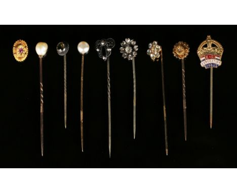 Two stick pins with cultured pearl finials, a citrine set stick pin, five further stick pins and a gold stick pin top.