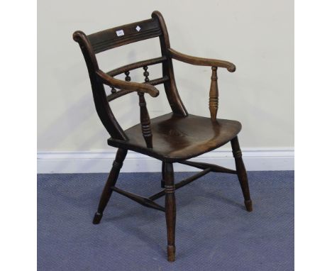 A George IV beech and elm provincial bar back elbow chair, the bobbin turned centre rail above a solid seat, on turned taperi