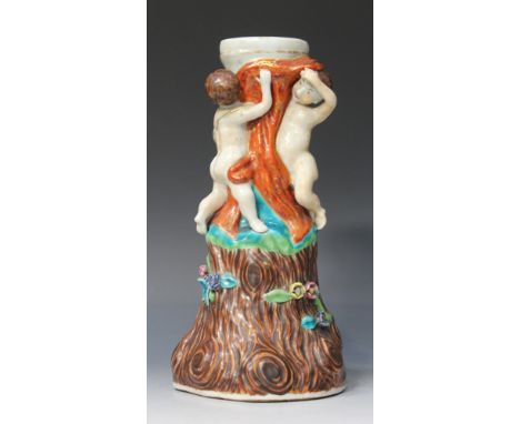 A Chinese European subject export porcelain column, 18th Century, modelled with two putto above applied polychrome flowers on
