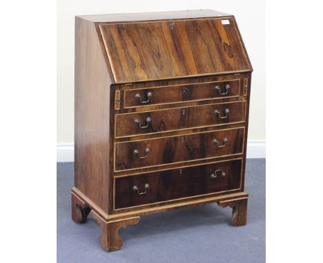 A 20th Century George III style rosewood bureau, the fall front revealing an interior of four drawers, pigeonholes and a cent