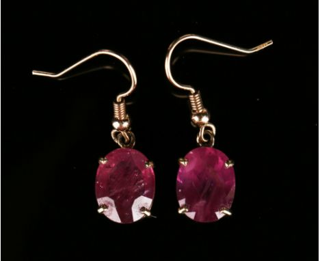 A pair of gold and ruby single stone earrings, each claw set with an oval cut ruby, with wire fittings, length approx 3cm, wi