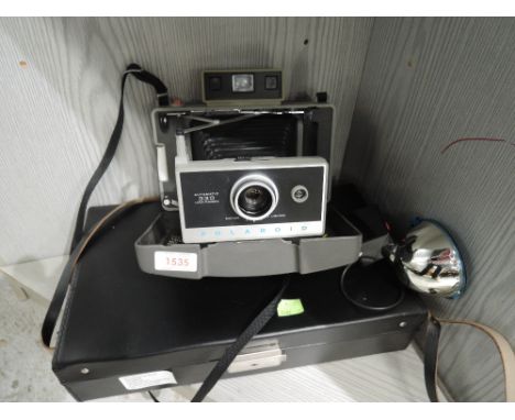A Polaroid Automatic 330 Land Camera with flash and original case