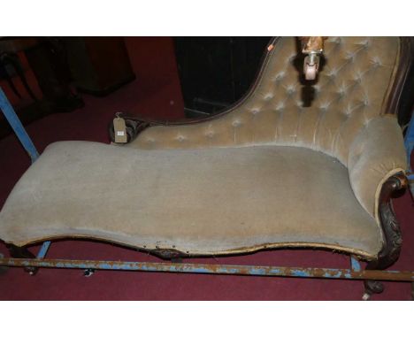 A late Victorian walnut framed salon settee with button back floral velour upholstery, raised on French cabriole forelegs wit