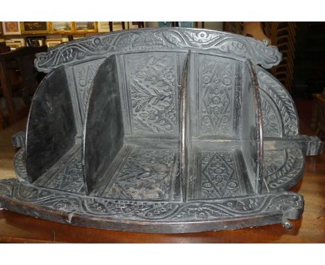 An antique carved and ebonised oak hanging corner shelf, h.103cm 