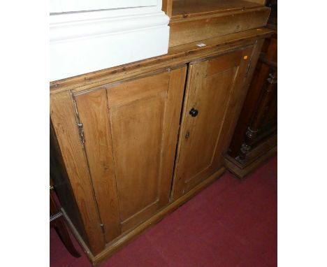 A pine double door cupboard, having a single shelf interior, w.105cm 