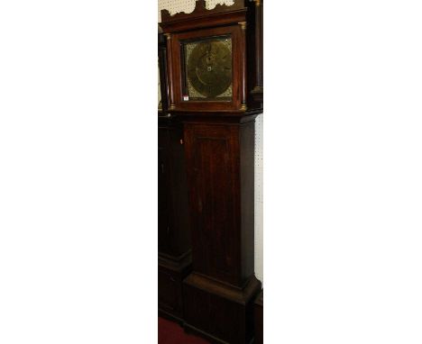 A late 18th century oak longcase clock having an unsigned 12" square brass dial with Arabic and Roman chapter ring, cast bras