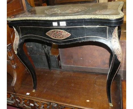 A mid Victorian ebony and boulle card table in the French taste, the hinged top (having losses to cut brass and red tortoises