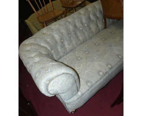 A late Victorian Chesterfield settee of good size, fully button backed, reupholstered, and on ring turned forelegs with casto