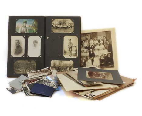A postcard album, with World War I era cards, photographs including loose, (qty)
