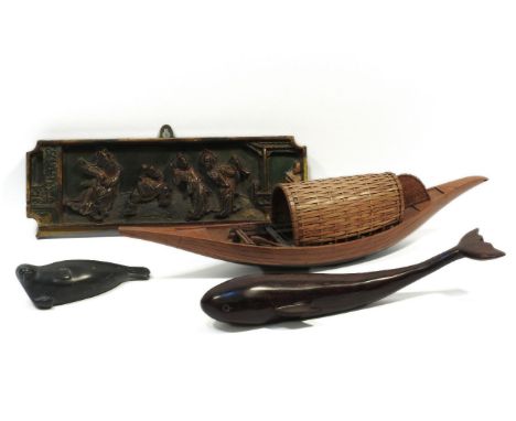 A North American slate carving of a seal, together a carved wooden whale, a wooden and wicker model of an Indonesian river bo