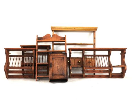 A set of pine hanging shelves, fitted drawers to base, an oak single door key cupboard, three pine plate racks and a hanging 