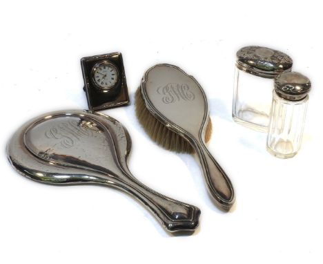 A collection of early 20th century silver dressing table items, two silver topped jars, a silver brush and mirror, and a boud