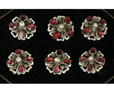 A cased set of six former Austro-Hungarian Empire garnet and enamel buttons, c.1900, each button composed of a baroque pearl,