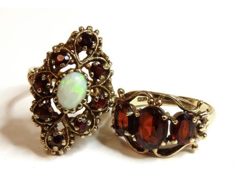 A 9ct gold opal and garnet lozenge shaped cluster ring, and a 9ct gold three stone garnet ring, 11.98g