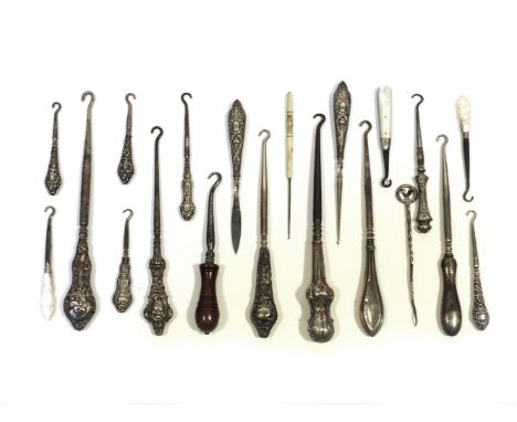 16 silver and mother of pearl handled button hooks, and 4 further items, in a glazed display case