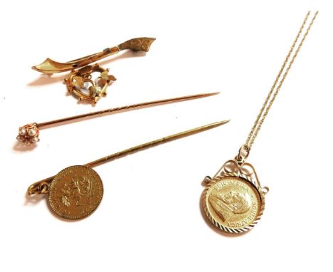 A 1/10 Krugerrand 1981 coin, in a 9ct gold mount on a 9ct gold chain, a gold ruby and split pearl stick pin, a gold brooch en