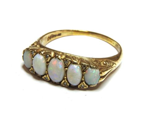 A five stone opal ring, with diamond set points, 6.00g