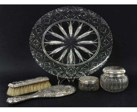 A silver topped three piece dressing table set, hallmarked, with embossed angel portrait decoration, a similar powder jar, an