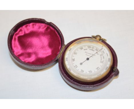 An old gilt pocket barometer in Morocco leather case