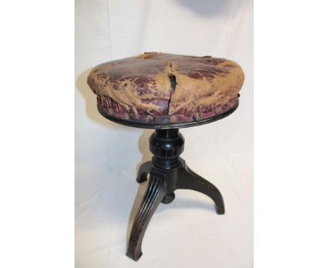 A Victorian ebonised and brass mounted adjustable piano stool with leather upholstered circular seat (af)
