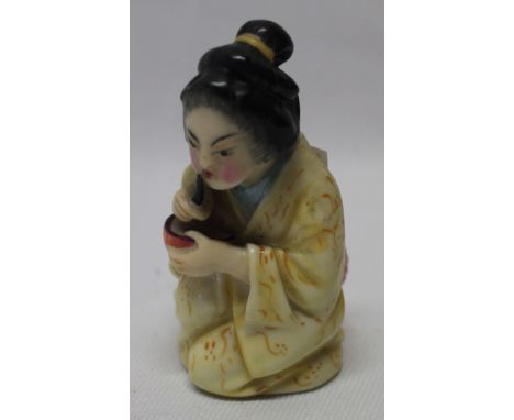 A Royal Worcester china candle snuffer in the form of a Chinese female