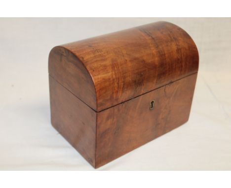 A 19th century figured mahogany domed tea caddy with interior twin-section enclosed by a hinged cover
