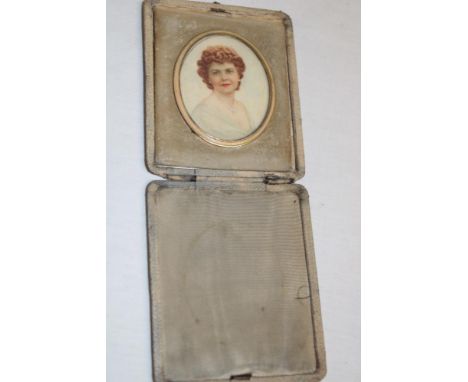 A miniature oval portrait depicting a bust portrait of a female in leather wallet