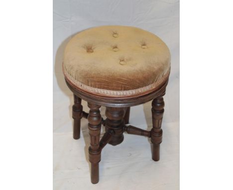 A Victorian walnut circular occasional stool with buttoned fabric top on turned legs