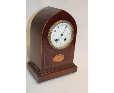 A French mantel clock with silvered circular dial in inlaid mahogany gothic arched case