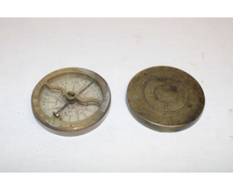 An early 19th century brass pocket compass with card circular dial, 2" diameter