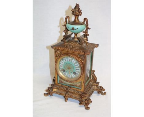 A French brass mantel clock with porcelain circular dial and porcelain scenic side panels 12 1/2" high